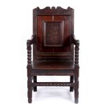 A 18TH CENTURY AND LATER PANELLED BACK JOINED OAK ARM CHAIR with shaped cresting and turned arm