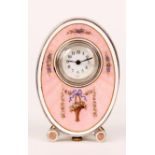 A SWISS LATE 19th CENTURY MINIATURE SILVER ENAMEL BOUDOIR CLOCK of oval form with swag work