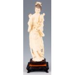 A LATE 19TH CENTURY CHINESE CARVED IVORY FIGURE the young lady in Oriental dress holding a lily