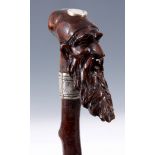 A 19TH CENTURY HAZEL WOOD GENTLEMANS WALKING STICK with sovereign holder and carved figure to the