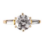 A 14CT YELLOW GOLD MODERN BRILLIANT CUT 1.75 CARAT SOLITAIRE DIAMOND RING with tapering baguette