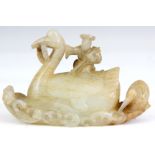 A CHINESE 18TH CENTURY JADE CARVING of a fisherman seated on a bird 8.5cm across 5cm high