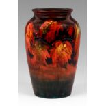 A WILLIAM MOORCROFT tapering shouldered vase tube lined and decorated in autumn colours with