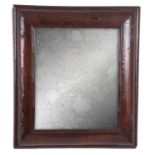 AN EARLY 18TH CENTURY WALNUT CUSHION FRAMED HANGING MIRROR with short grain D shaped mouldings and