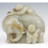 A 18TH CENTURY CHINESE CARVED JADE ELEPHANT WITH ATTENDANT FIGURES 8cm wide 7.5cm high.