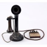 AN EARLY CANDLESTICK TELEPHONE with enamelled number dial and bakelite earpiece, the base with