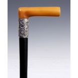 A LATE 19th CENTURY HORN HANDLED WALKING CANE with tapering ebonised stick and silver collar