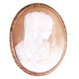 A GOLD MOUNTED CAMEO BROOCH portrait of a lady with engraved decoration to mount 54mm long, 42mm