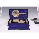 AN ART NOUVEAU CASED SILVER FIVE PIECE DRESSING TABLE SET stylishly decorated with embossed tulips -