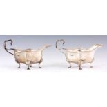 A PAIR OF EARLY 20TH CENTURY SILVER SAUCE BOATS of shaped form standing on squat cabriole legs 15.