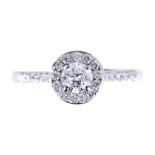 A PLATINUM SOLITAIRE DIAMOND RING with halo setting and diamond set shoulders, centre stone 35