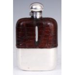 AN OVERSIZED CROCODILE SKIN AND SILVER-PLATED HIP FLASK BY JAMES DIXON AND SONS having a removable