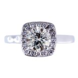 AN 18ct WHITE GOLD SOLITAIRE DIAMOND RING with halo setting, centre stone 1.22 carat, halo 25 points