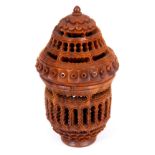 A LATE 19TH CENTURY CARVED CONQUILLA NUT BOX with pierced work decoration and screw off lid, 8cm