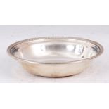 AN AMERICAN SILVER CIRCULAR DISH of plain design with ribbed edge 14.5cm diameter - Stamped Sterling