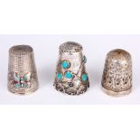 A SILVER AND TURQUOISE MOUNTED THIMBLE and two other