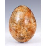 A 19TH CENTURY LARGE QUARTZ EGG POSSIBLY BLUE JOHN with brown inclusions 9.5cm overall.