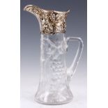 A STYLISH AMERICAN SILVER MOUNTED CUT GLASS CLARET JUG with embossed grape vine decoration 28cm high