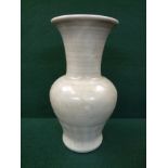 Chinese Celadon vase with banded neck above scroll baluster in green glaze, unglazed base, 26cm in