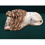 19thC Sitzendorf Sleeping Lion with blue underglaze mark, 28cm in length