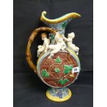 Minton Majolica Barrel Ewer decorated with applied cherub decoration over vine leaves by Hugh Protat