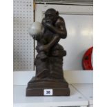 Interesting Canadian Darwin figure of a monkey with skull sculpture, 33cm in Height