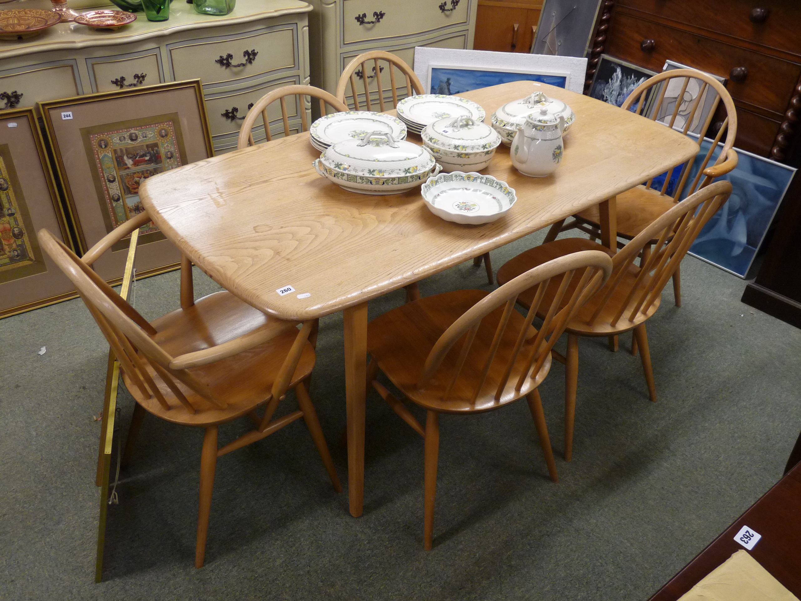 Ercol Blonde Elm dining table on outstretched legs and a matching set of 6 Ercol Windsor chairs