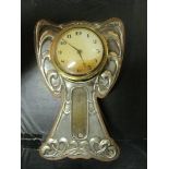 An Art Nouveau silver faced clock with thermometer (a/f)