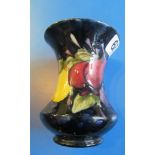 A Moorcroft vase fruit design on dark blue ground.