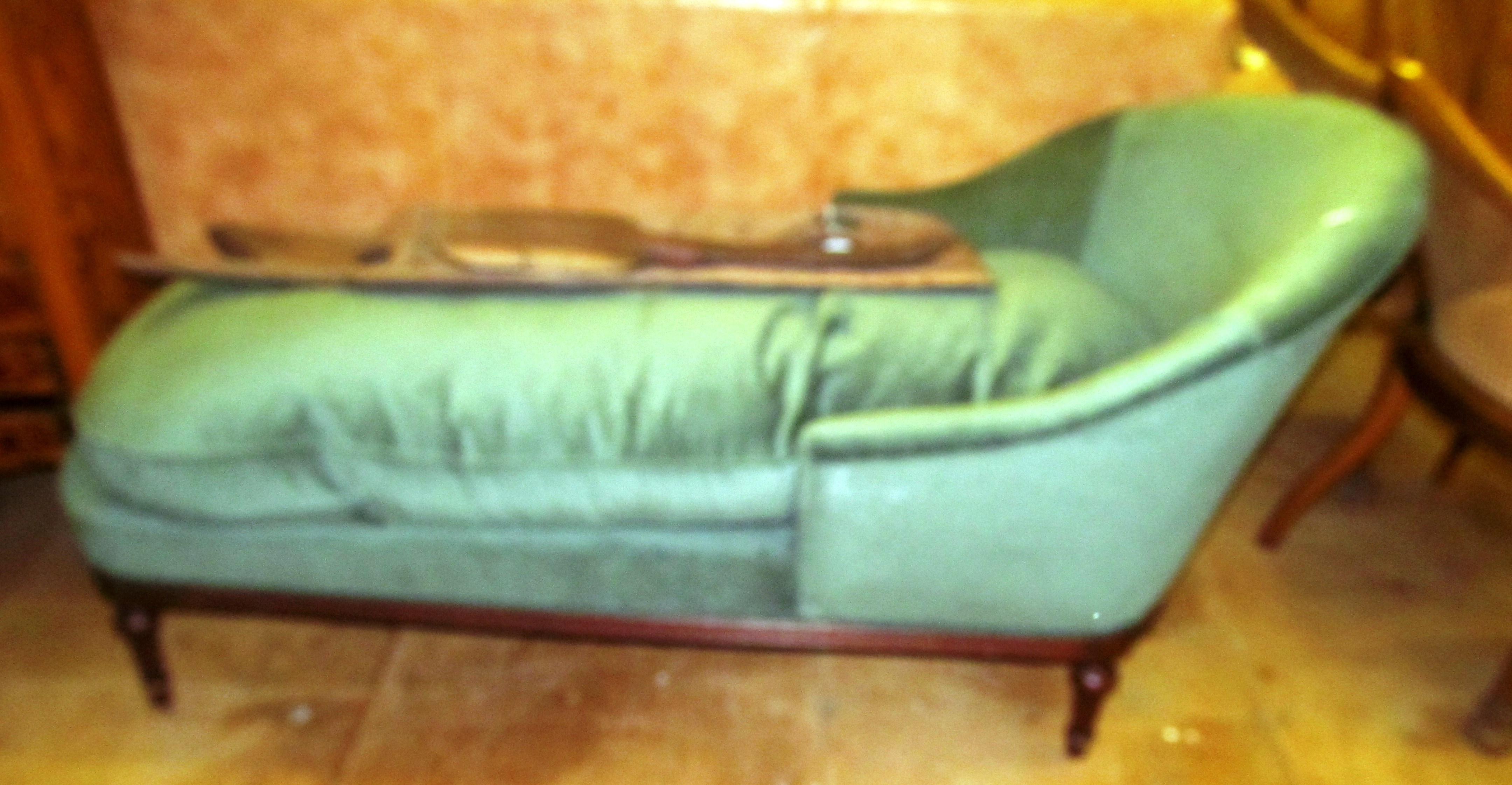 A chaise longue with loose cushion