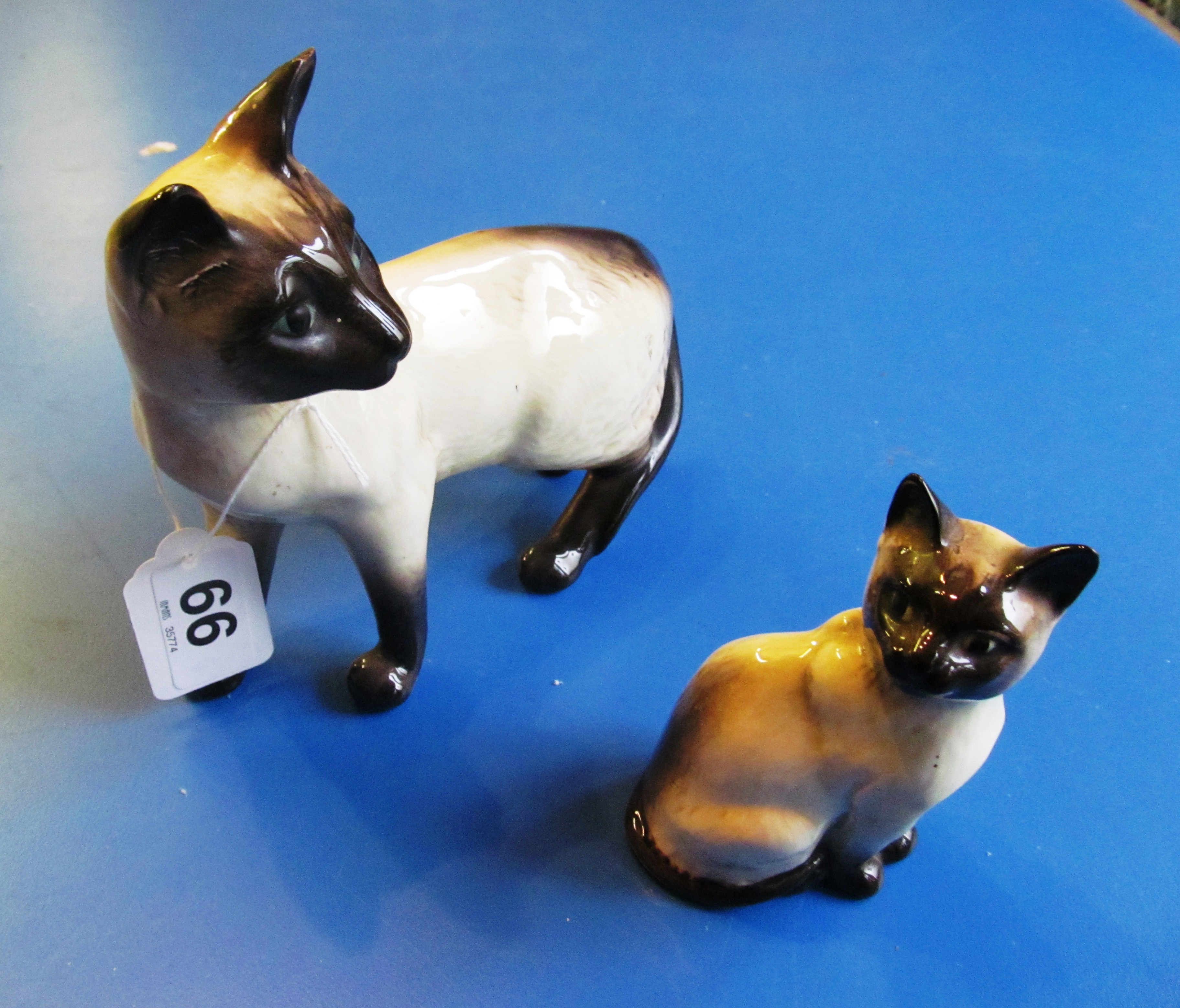 Two Beswick Siamese cats.