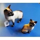 Two Beswick Siamese cats.