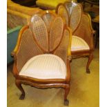 A pair of similar shield back cane chairs