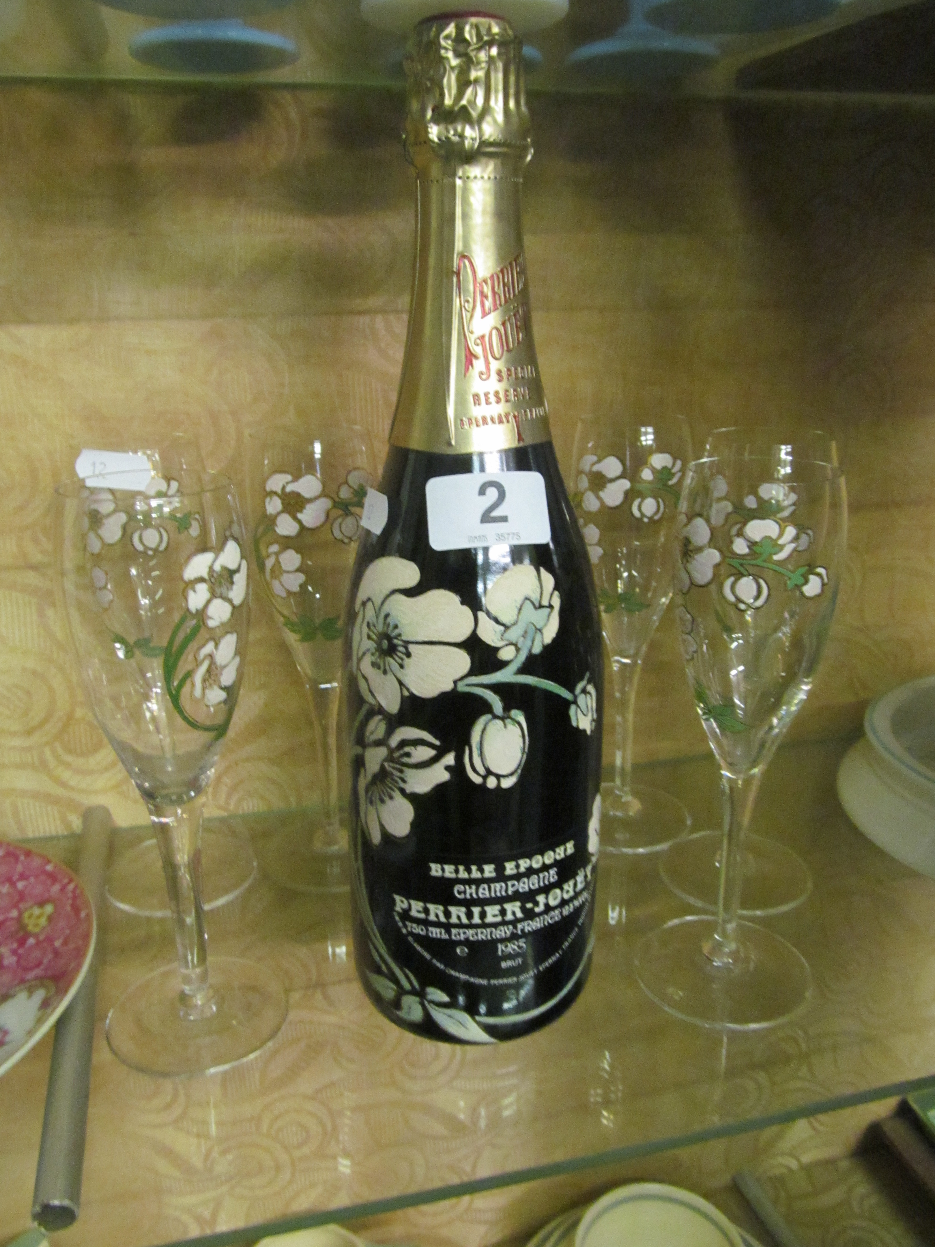 A bottle Belle Époque Champagne 1985 and seven glasses