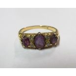 A gold ring set amethyst and diamond chips