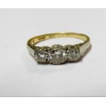 An 18ct gold and platinum three stone diamond ring