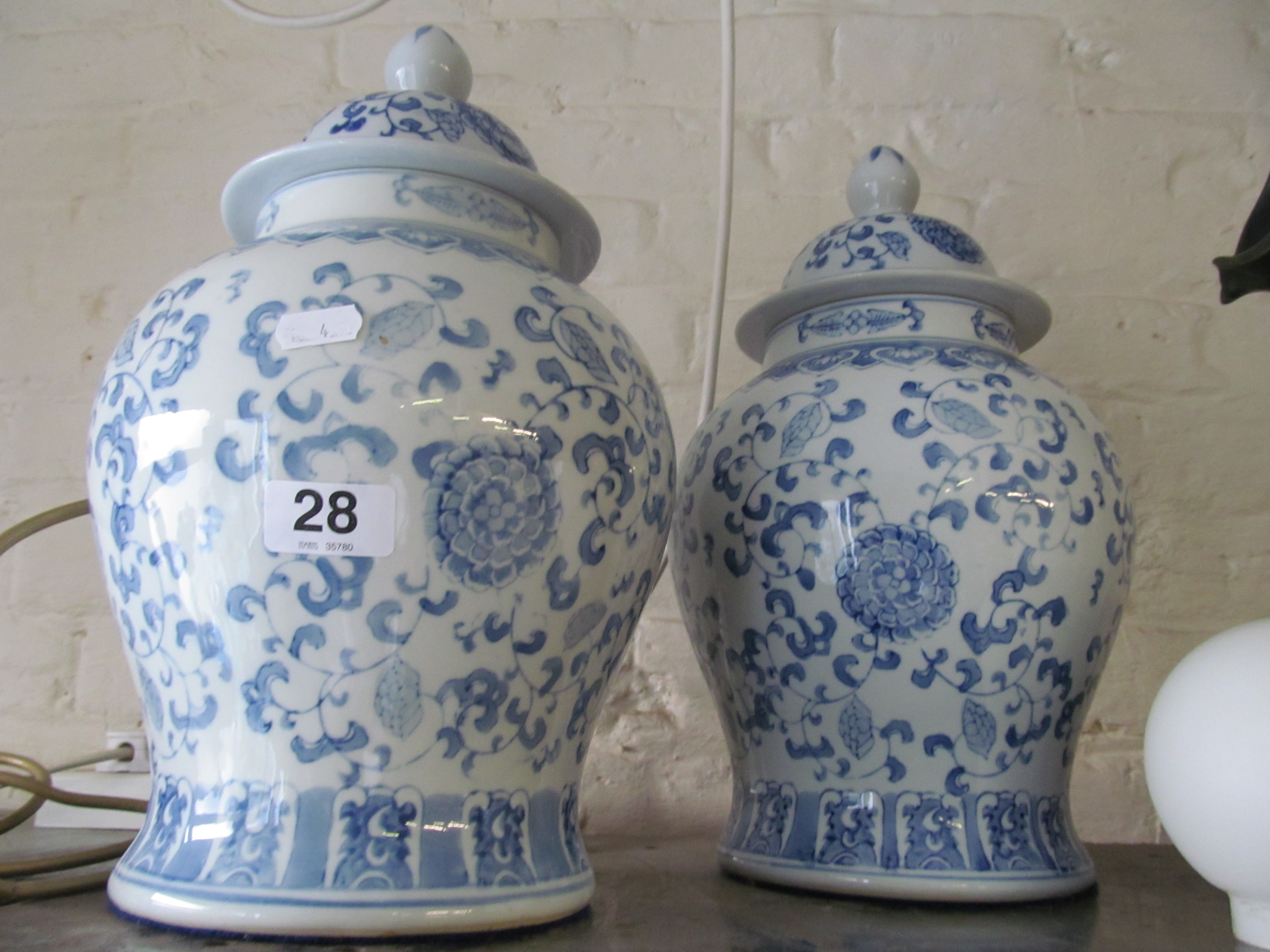 A pair of blue and white lidded vases.