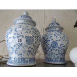 A pair of blue and white lidded vases.