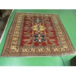 A Kelim style rug of red ground with three medallions