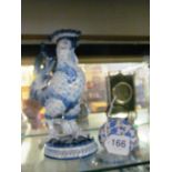 A Continental china cockerel candlestick and china bag