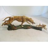 An ornament greyhound chasing hare.