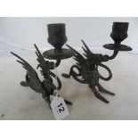 A pair of winged dragon candlesticks