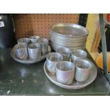 A set of eleven metal Japanese plates and cups