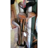 A canvas golf bag with collection of hickory shafted clubs