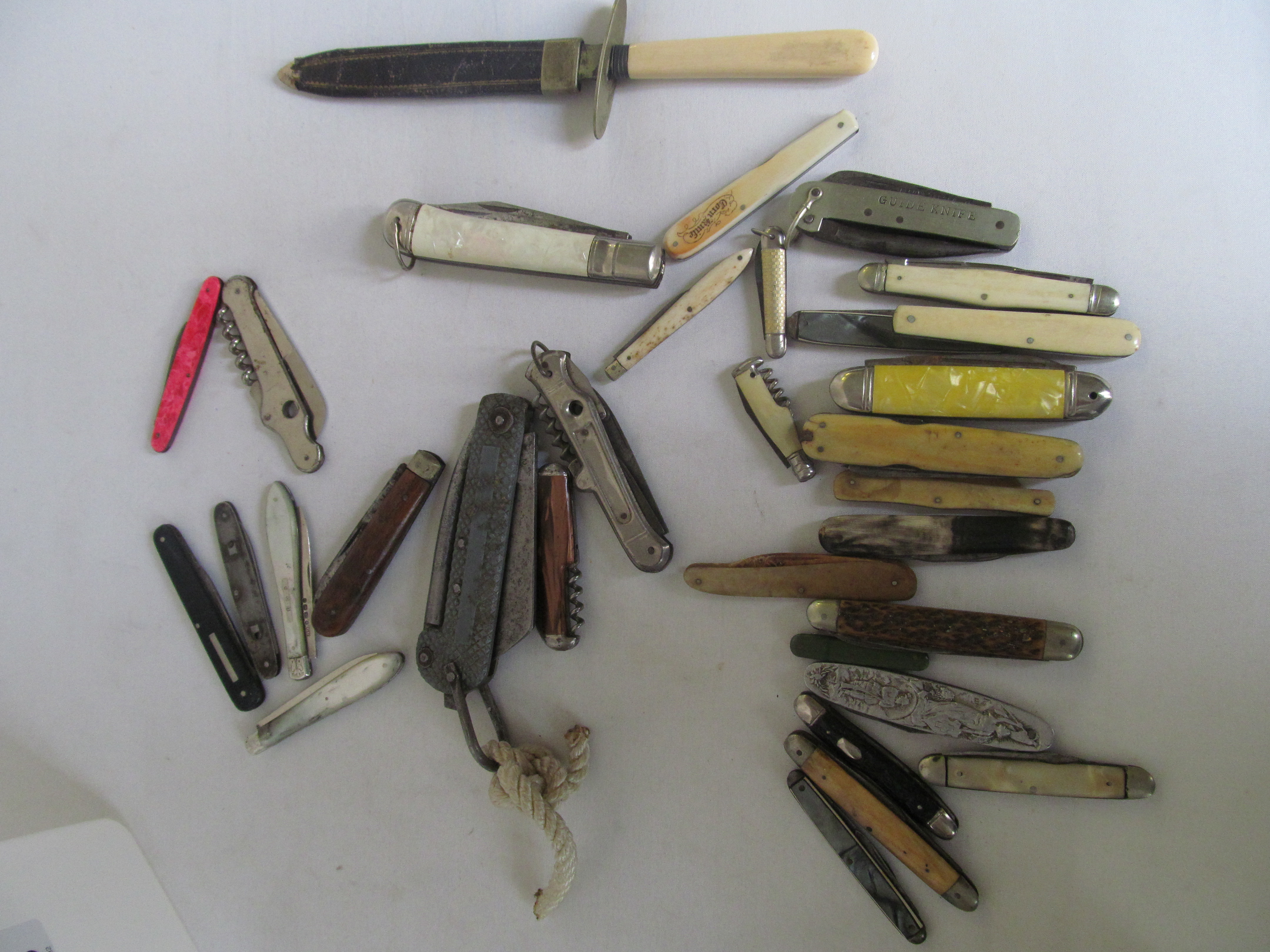 A collection of fruit and pocket knives.