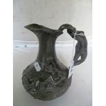 A French pewter jug with semi-naked lady on handle and two cherubs on woodland floor, marked Etain