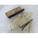 A Victorian leather glove box and collection of gloves, and two stretchers.