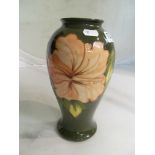 A Moorcroft vase decorated pink flowers.