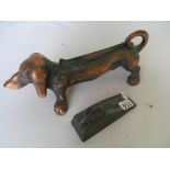 A copper dog, front grate, and mouse door stop.