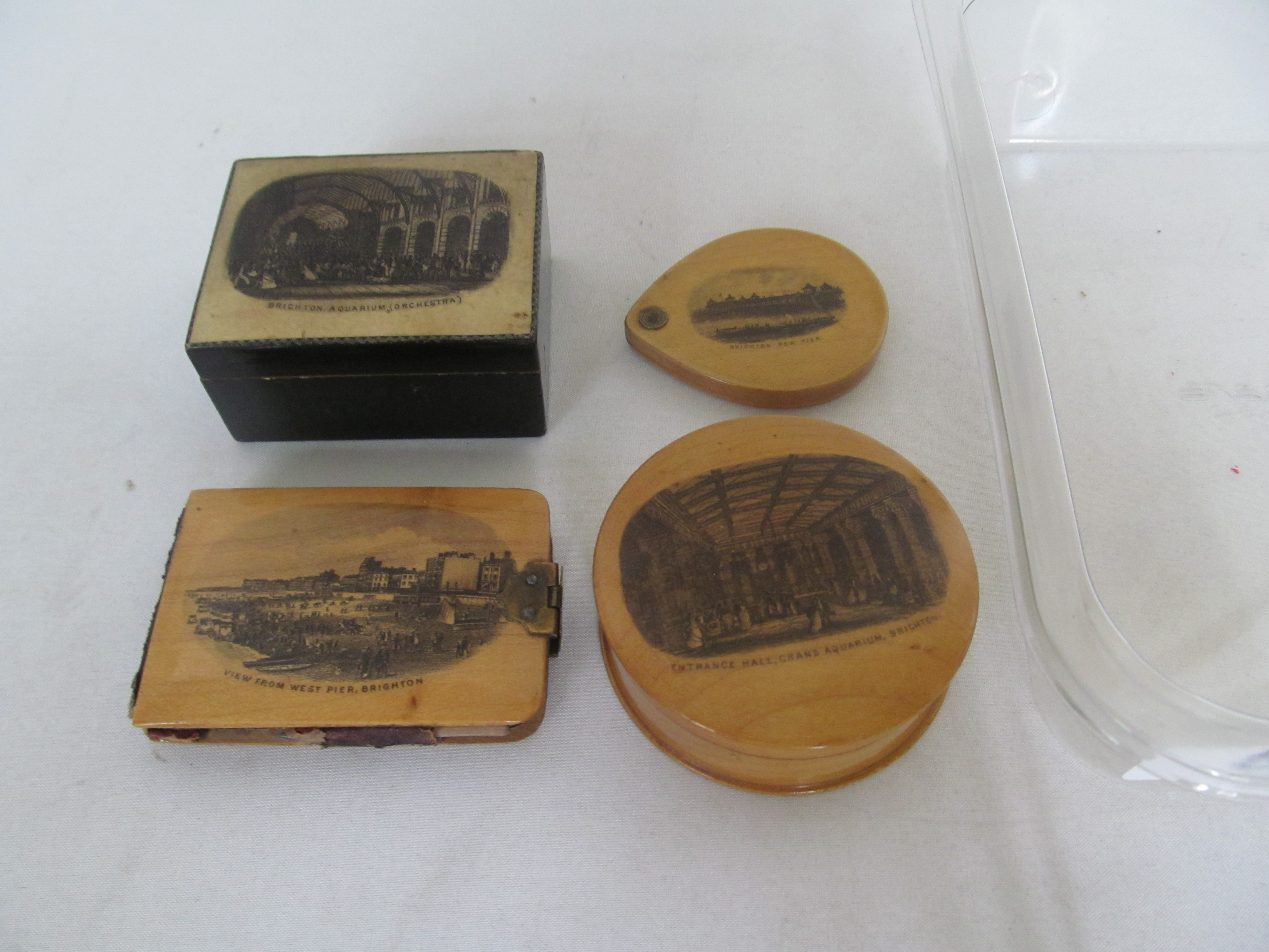 Four Victorian Mauchlinware Brighton Souvenirs with views of the New Pier, West Pier, and